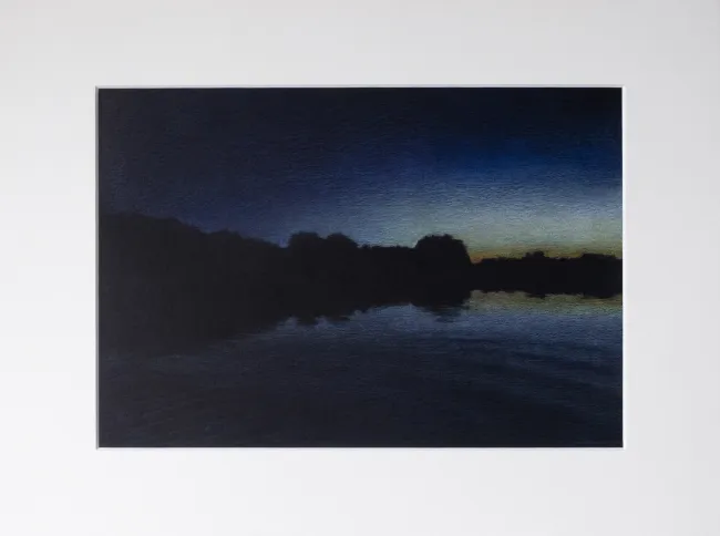 lake at night long after sunset, only some light on the horizon and some refelctions in the water are visible